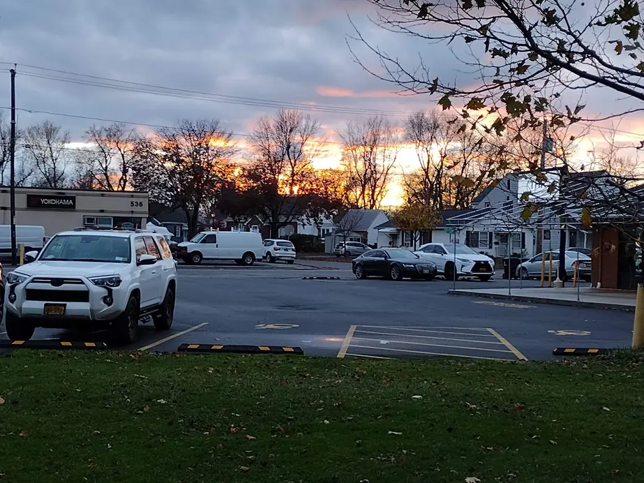 The Bailey Tire lot on Englewood Avenue at dusk, with the 536 address sign lit